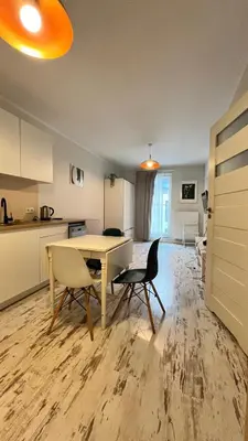 a small bedroom with a bed and a table and chairs at Ślusarska Street in Kraków