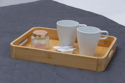 a wooden tray with three coffee cups and a jar at Cosy Apartments with Air Conditioning by Noclegi Renters in Kraków