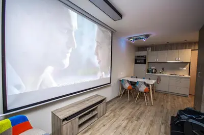 a large screen on a wall in a living room at Studio Apartment with projector and balcony between Main Square and Kazimierz Quarter in Kraków