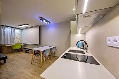a kitchen with a sink and a table with chairs at Studio Apartment with projector and balcony between Main Square and Kazimierz Quarter in Kraków
