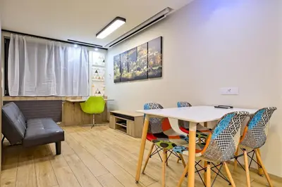 a dining room with a table and chairs at Studio Apartment with projector and balcony between Main Square and Kazimierz Quarter in Kraków
