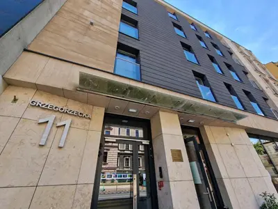 a building with the entrance to a store at Unique Studio Apartment with 2 balconies with Wawel Castle and city views in Kraków