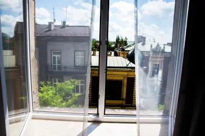 an open window with a view of a building at Just4You Apartments in Kraków