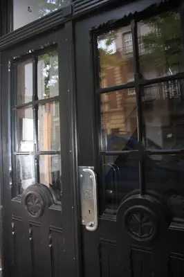 a black door with two windows and a car in it at Just4You Apartments in Kraków