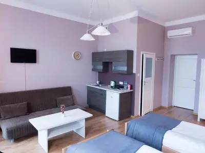 a living room with a couch and a table at Just4You Apartments in Kraków