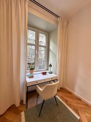 a room with a desk and a chair in front of a window at Modern DeLux Apartment! - air conditioning in Kraków