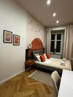 a bedroom with a bed with orange pillows at Modern DeLux Apartment! - air conditioning in Kraków