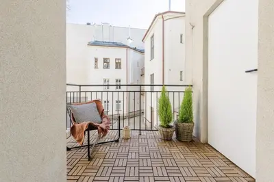 a balcony with a chair and potted plants at Modern DeLux Apartment! - air conditioning in Kraków