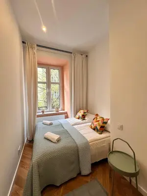 a small bedroom with a bed and a window at Modern DeLux Apartment! - air conditioning in Kraków