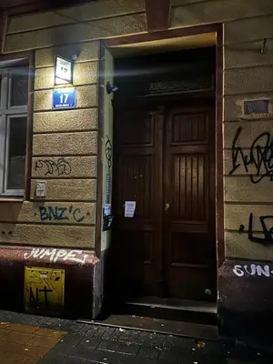 a door to a building with graffiti on it at Modern DeLux Apartment! - air conditioning in Kraków