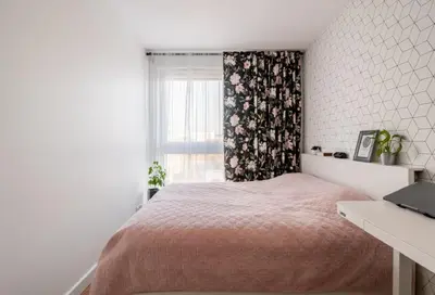 a white bedroom with a bed and a window at Zoya Apartament in Kraków