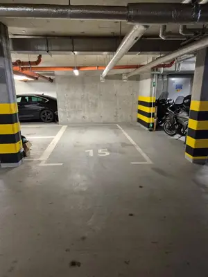 a parking lot with cars parked in a parking garage at Megga Apartament z Garażem, FV in Skawina