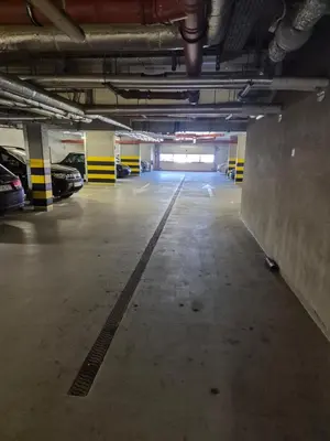 an empty parking garage with cars parked in it at Megga Apartament z Garażem, FV in Skawina