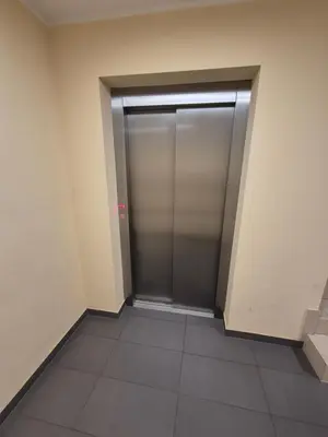a elevator door in a building with a tile floor at Megga Apartament z Garażem, FV in Skawina
