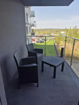 a balcony with two chairs and a coffee table on a building at Megga Apartament z Garażem, FV in Skawina