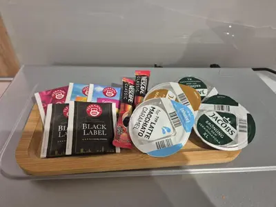 a bunch of books on a wooden tray on a table at Megga Apartament z Garażem, FV in Skawina