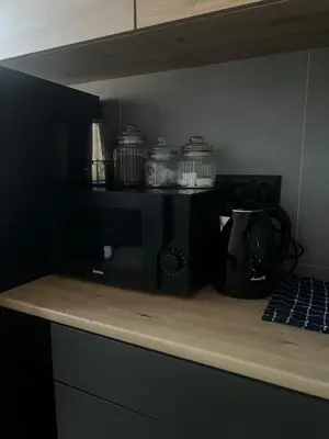 a kitchen with a counter top with a microwave at Klimatyczna Antresola nad Wisłą in Kraków