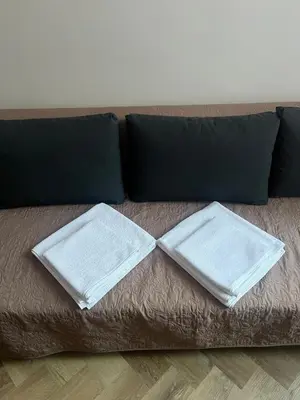 a brown couch with two pillows on it at Klimatyczna Antresola nad Wisłą in Kraków