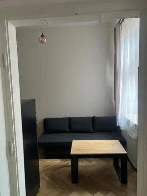 a living room with a couch and a table at Klimatyczna Antresola nad Wisłą in Kraków