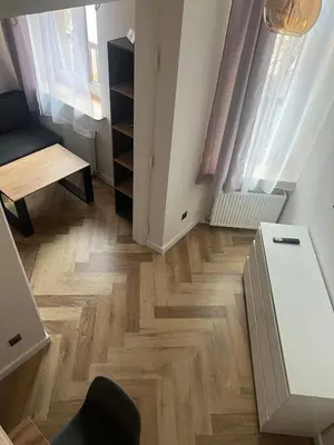 a room with wooden floors and curtains and a desk at Klimatyczna Antresola nad Wisłą in Kraków