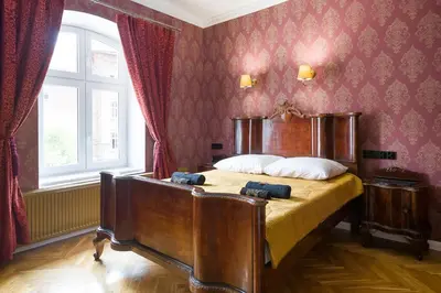 a bedroom with a large bed in a room at Malila Premium Apartments Cracow Lubicz 14 in Kraków