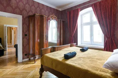 a bedroom with a bed with two blue pillows on it at Malila Premium Apartments Cracow Lubicz 14 in Kraków