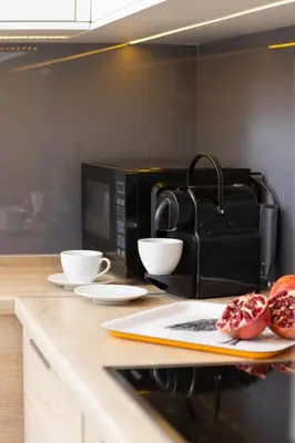 a counter with two donuts and a microwave at Dietla Studio with a mezzanine in the center of Kraków by Noclegi Renters in Kraków