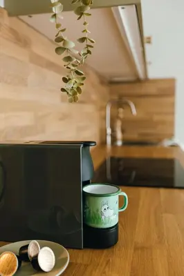 a coffee pot sitting on a table next to a plate at Kątowa Studio - Sauna, AC, balcony in Kraków