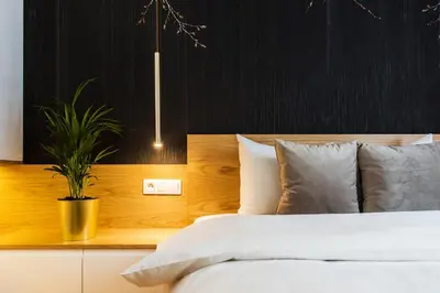 a bedroom with a blue couch and a mirror at Bed&Bath Modern Old Town Apartments in Kraków