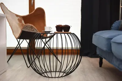 a bedroom with a white bed and a wall with branches at Bed&Bath Modern Old Town Apartments in Kraków