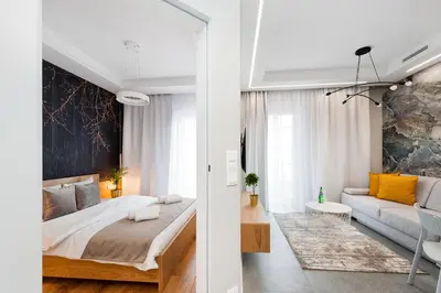 a living room with a couch and a table at Bed&Bath Modern Old Town Apartments in Kraków