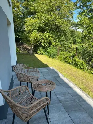 two chairs and a table on a patio at SOLAPART Apartamenty in Oświęcim
