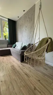 a room with a couch and a hammock in a room at Rivershine Apartment Cracow in Kraków
