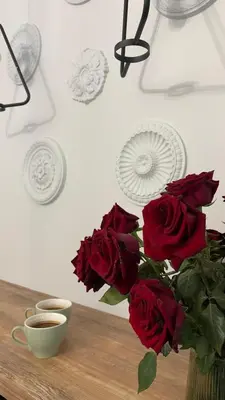 a bouquet of red roses in a vase on a table at Rivershine Apartment Cracow in Kraków
