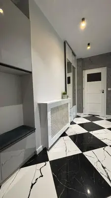 a room with a black and white checkered floor at Rivershine Apartment Cracow in Kraków