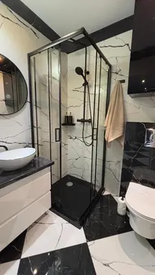 a bathroom with a shower with a sink and a toilet at Rivershine Apartment Cracow in Kraków