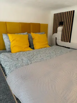a bedroom with a bed with yellow pillows at Parrot Apartment Main Station Cracow in Kraków