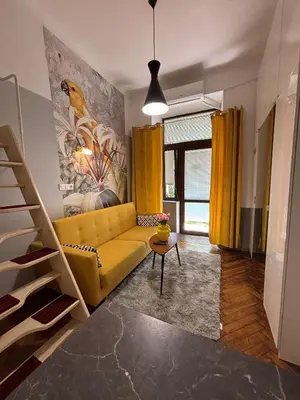 a living room with a yellow couch and yellow curtains at Parrot Apartment Main Station Cracow in Kraków