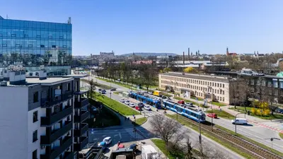 a view of a city with a train on a street at Grzegórzki Comfy Apartment by BookingHost in Kraków