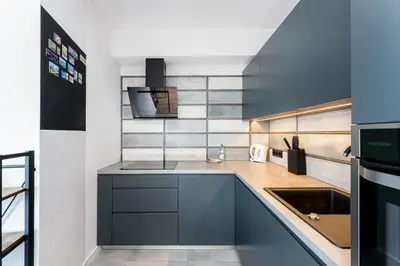 a kitchen with a sink and a counter top at Grzegórzki Comfy Apartment by BookingHost in Kraków