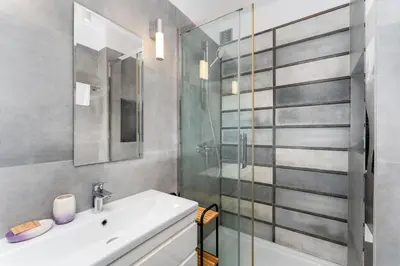 a bathroom with a sink and a shower at Grzegórzki Comfy Apartment by BookingHost in Kraków