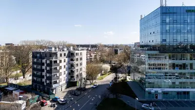 an aerial view of a city with a tall building at Grzegórzki Comfy Apartment by BookingHost in Kraków