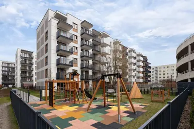 a playground in front of a apartment building at Nowoczesny Apartament w Krakowie z Klimatyzowanym Salonem Dwa Miejsca Postojowe by Noclegi Renters in Kraków