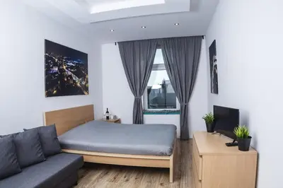a bedroom with a bed and a couch at Magic Place parking, Air Conditioning, Self Check In in Oświęcim