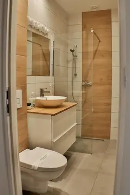 a bathroom with a toilet and a sink and a shower at Magic Place parking, Air Conditioning, Self Check In in Oświęcim