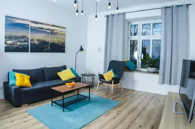 a living room with a couch and a table at Magic Place parking, Air Conditioning, Self Check In in Oświęcim