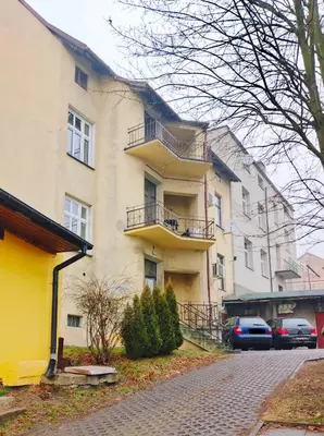 a bedroom with a bed and a couch with a tv on the wall at Magic Place parking, Air Conditioning, Self Check In in Oświęcim