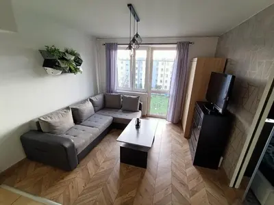 a living room with a couch and a tv at Perfekt Place in Oświęcim