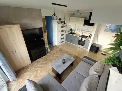 a living room with a couch and a table at Perfekt Place in Oświęcim