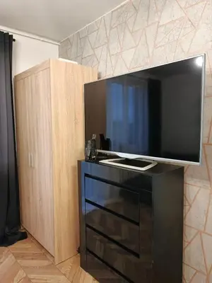 a large flat screen tv sitting on top of a dresser at Perfekt Place in Oświęcim
